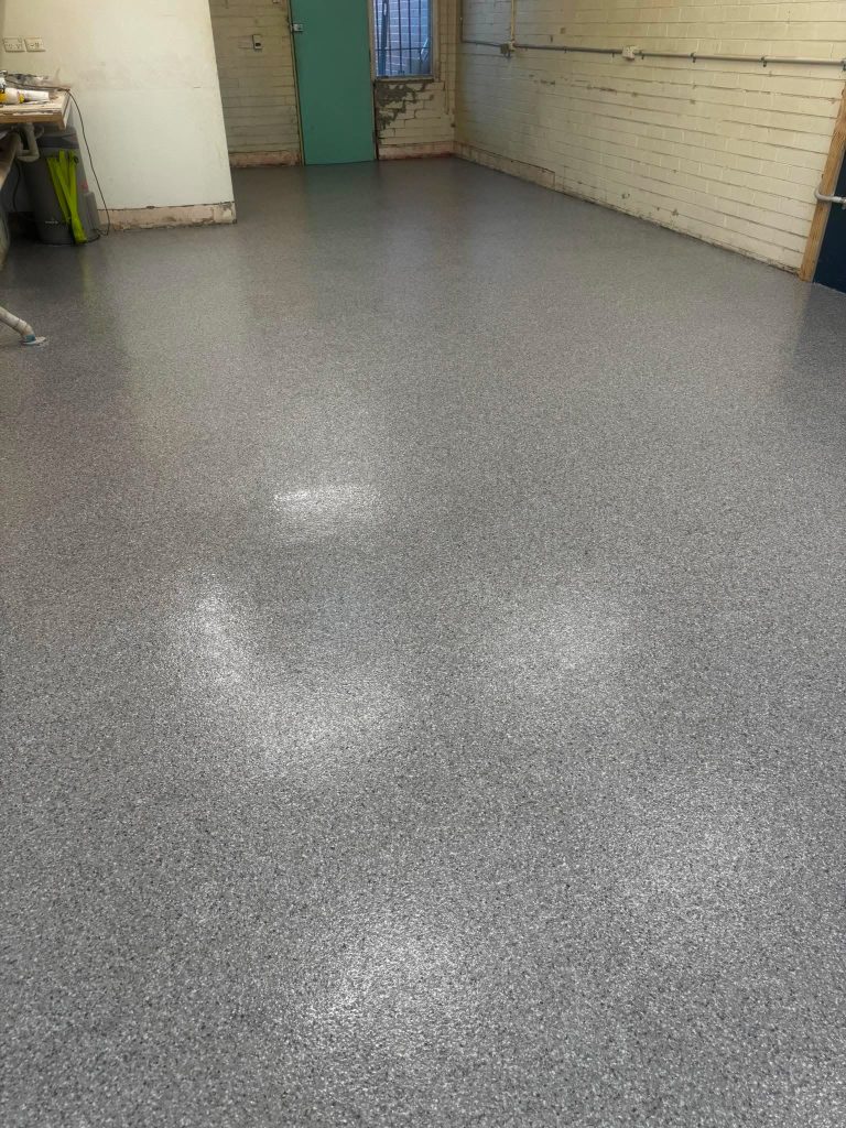 Completed commercial epoxy flake flooring installed in a retail shop in Rosebud