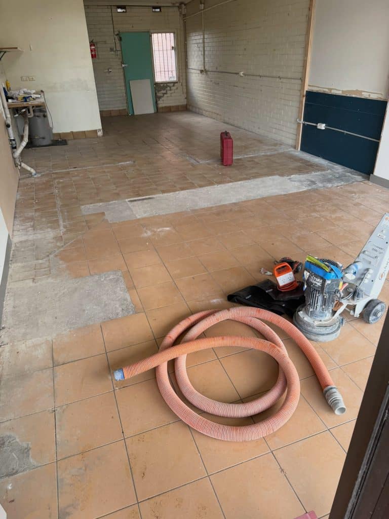 Commercial shop floor before epoxy flake flooring installation in Rosebud