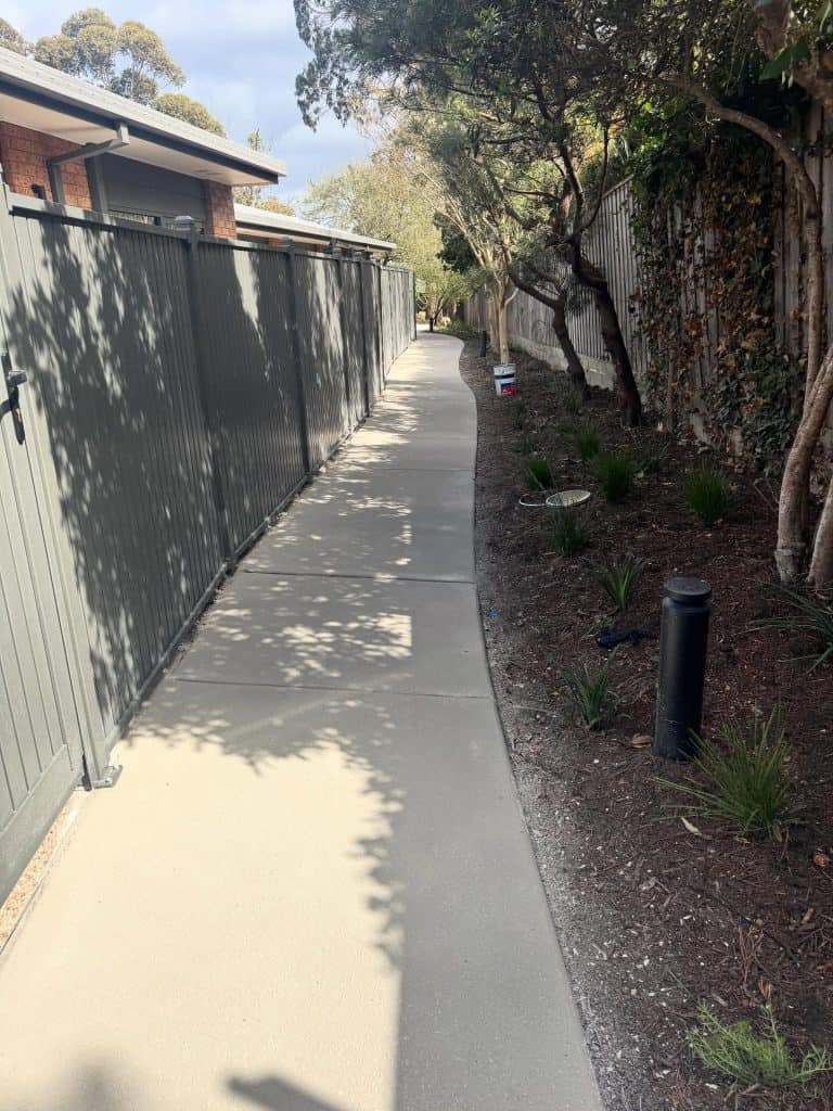 Resurfaced concrete footpath alongside a fence at an aged care facility in Nunawading