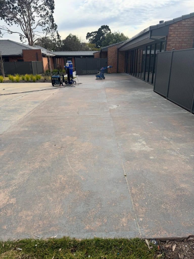 Worn concrete driveway before resurfacing at an aged care facility in Nunawading