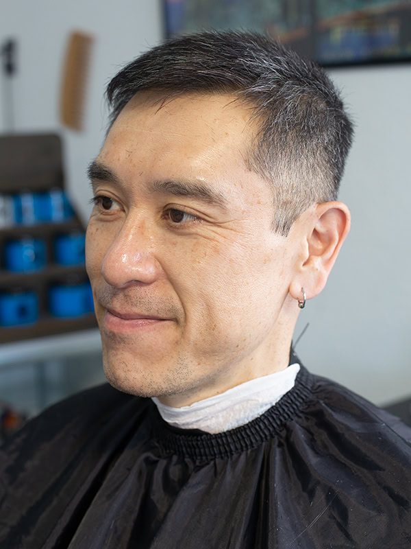 A man with clean Men's haircut at a barbershop