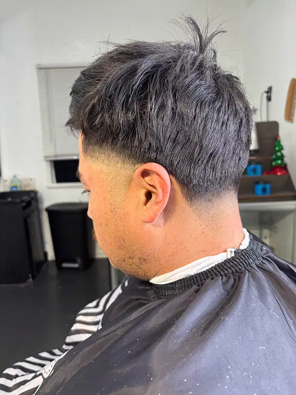 a finished mid taper fade at a barber shop