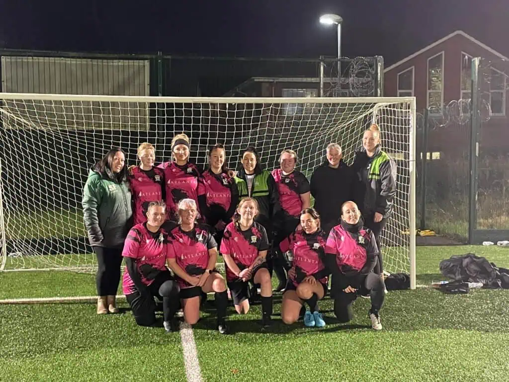 Sherree Fearon and the Sublime Athletic FC women’s team standing together in front of the goal, highlighting volunteer coaching work celebrated by O’Donnell Solicitors.