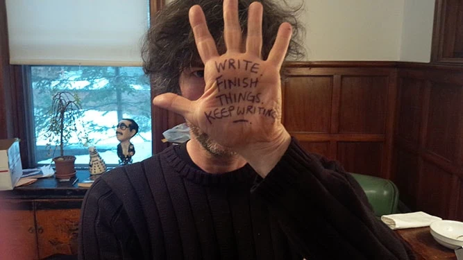 Writing on Gaiman's hand: "Write. Finish things. Keep writing."