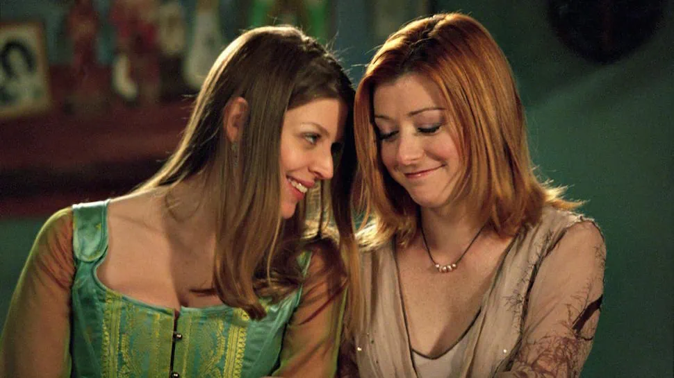 Tara and Willow sit together on Buffy