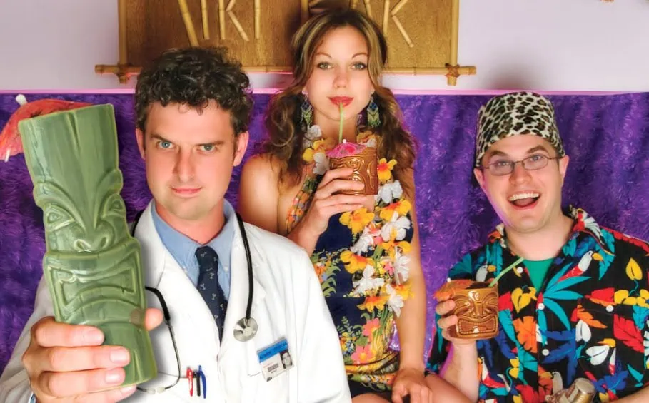 Dr. Tiki offering "cheers" with Lala and Johnny Johnny.