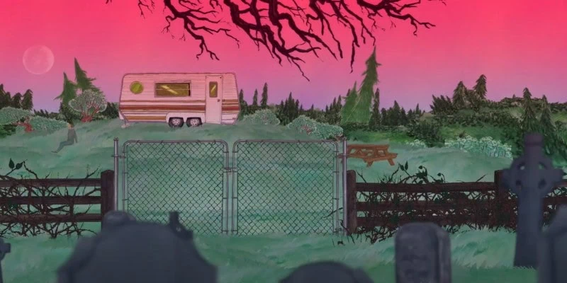 Trailer overlooking the graveyard under a red sunset