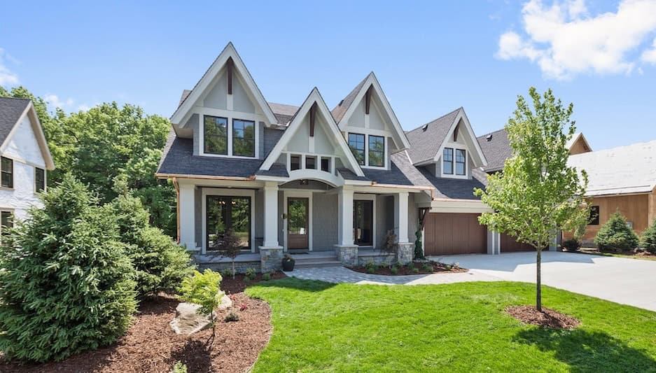 A home with a beautiful lawn and garden.
