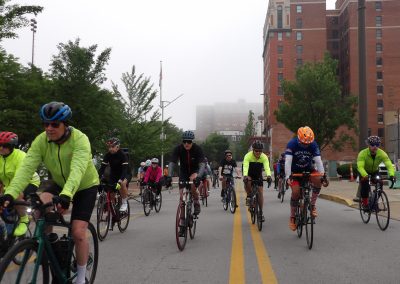 Cyclists riding on a city street during a community event.