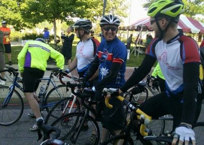 Group of cyclists at Ohio Valley Trail Partners event in a park.