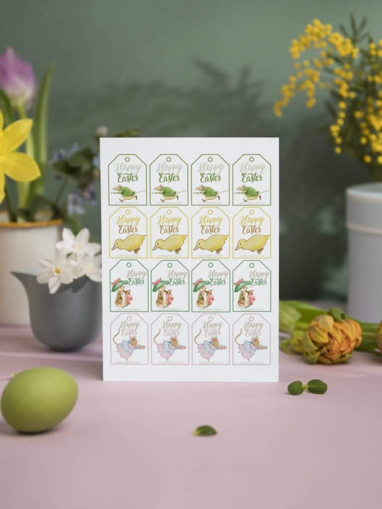 Peter Rabbit and Friends illustrated Easter gift tags on a sheet displayed with flowers and plants in pots.