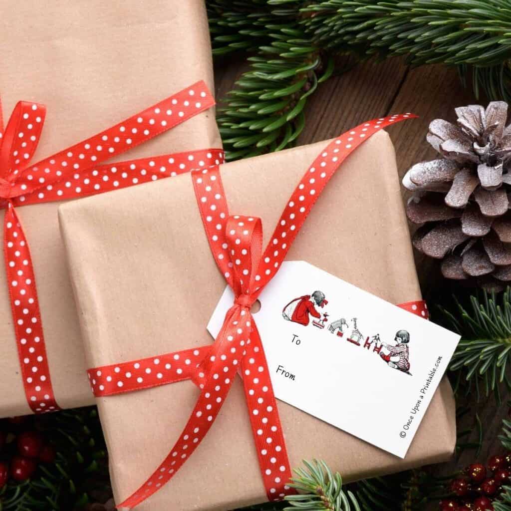 Simple vintage Christmas gift tags on brown paper wrapped boxes and red ribbon, adorned with a vintage illustration by Jessie Willcox Smith's version of Twas the night before Christmas story.