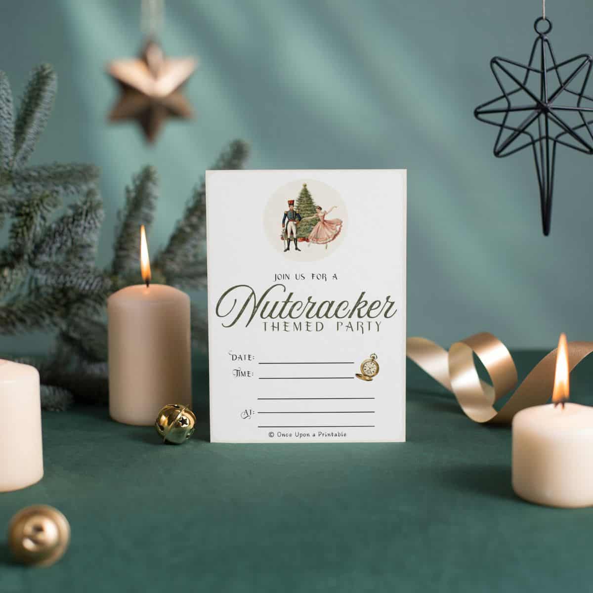 Nutcracker themed party invitations next to lit candles on green velvet and a christmas tree.