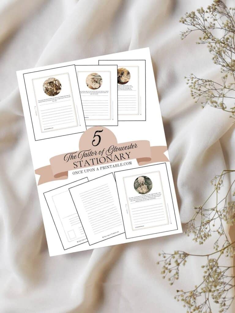 Cover page for 5 free the tailor of gloucester stationary sets laying on a white sheet with baby's breath flowers.