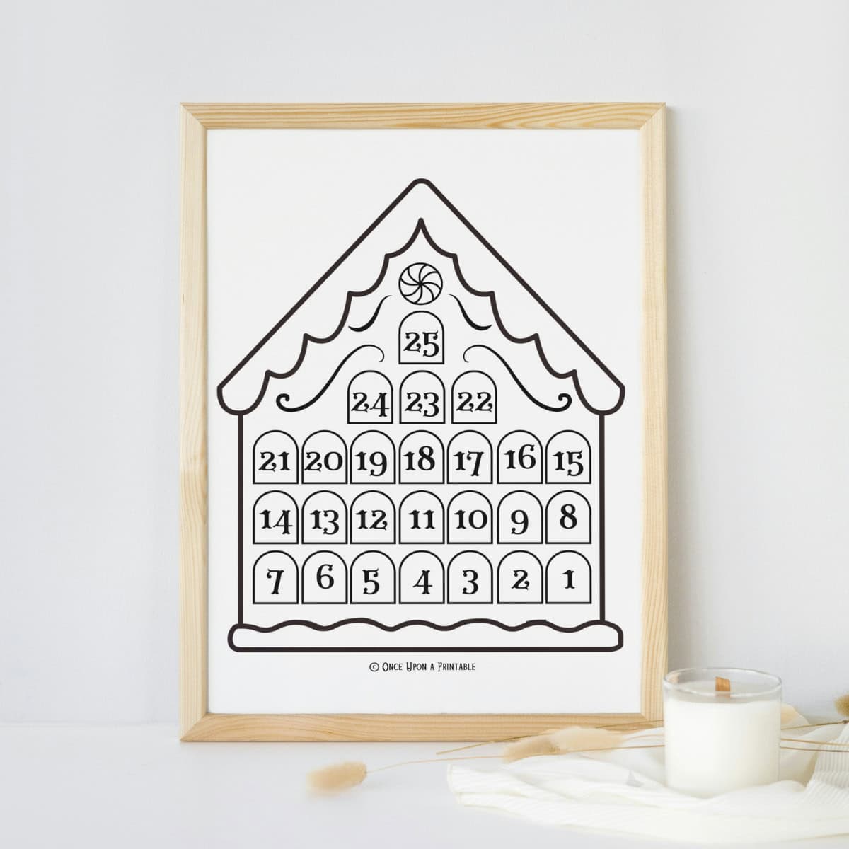 Gingerbread house christmas coloring countdown page framed and displayed by a candle.