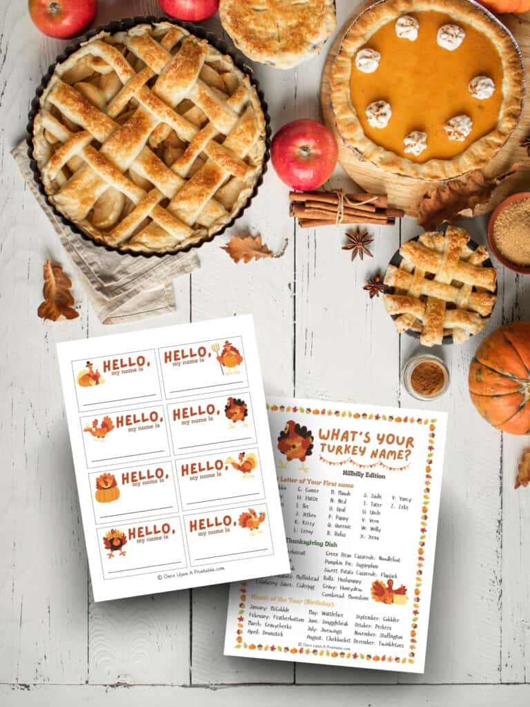 What's your turkey name printable with fun turkey graphics displayed on a wooden surface with apple pieces and pumpkins.