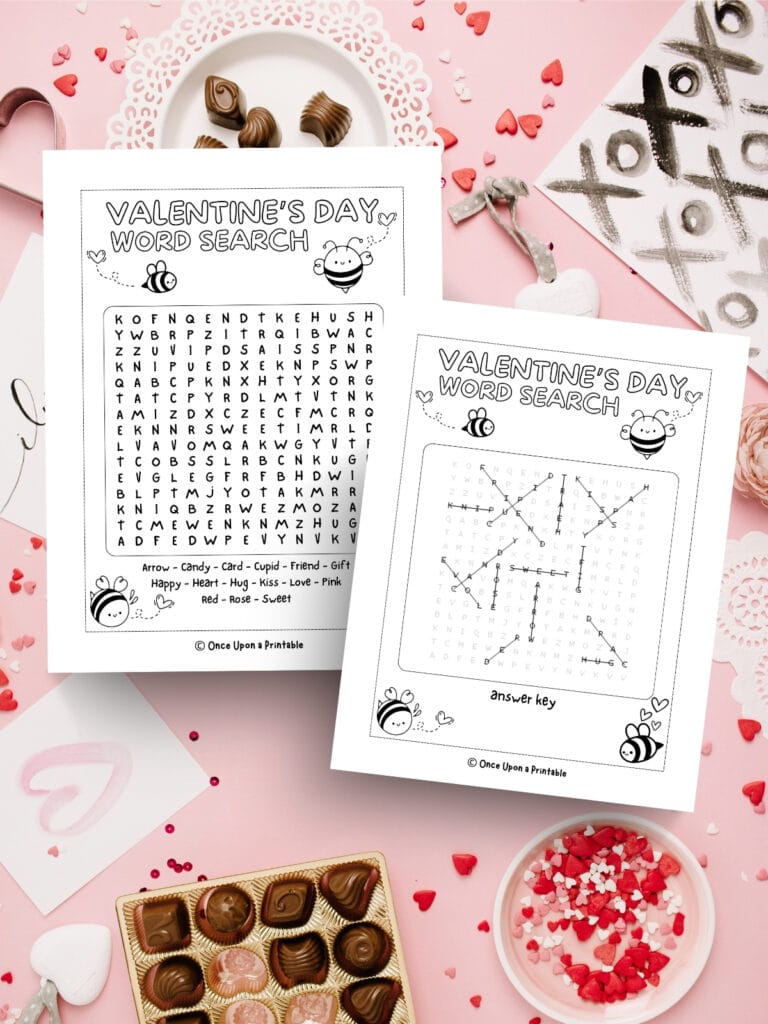 Honey bee themed Valentine's Day crossword puzzle with answer key printed and laying on a messy candy background.