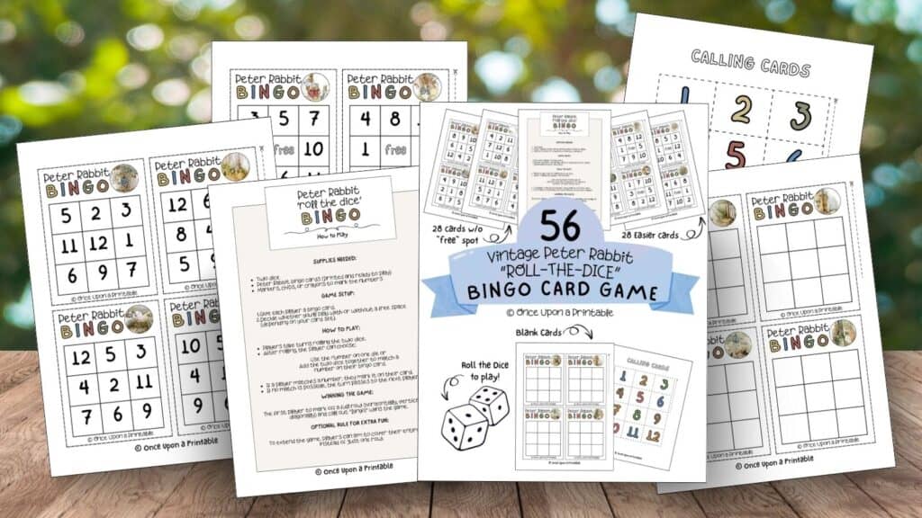 Peter Rabbit illustrated bingo card game set papers printed and laying on a wooden table with trees in the background.