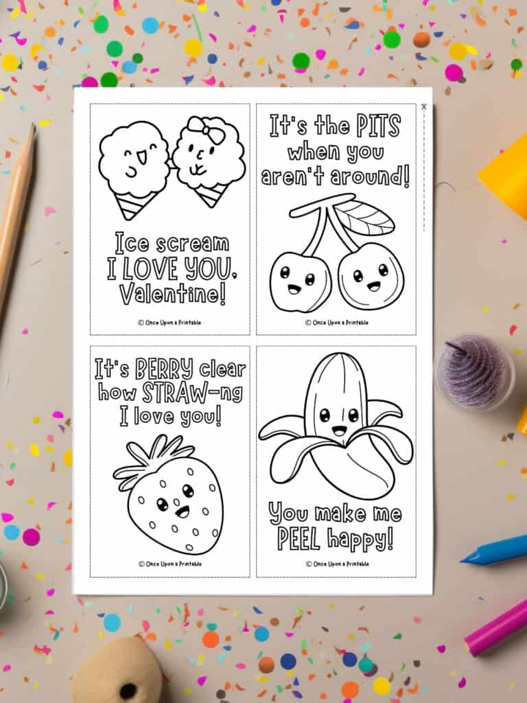 Cute Valentine's day cards to color printed and laying on a paint splattered background with coloring pencils.