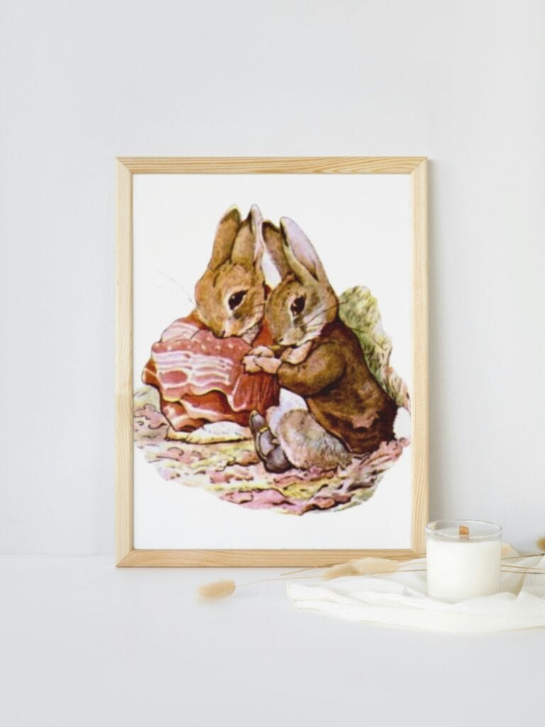 Benjamin Bunny and Peter Rabbit illustration framed and sitting on a table with a candle.
