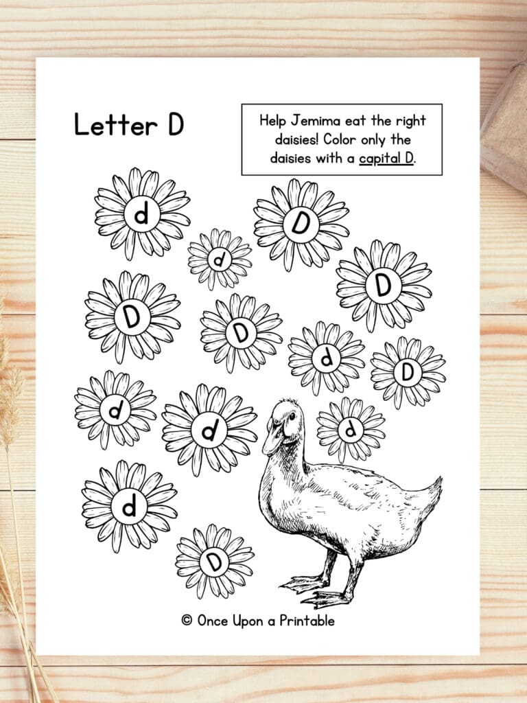 Letter D duck capital and lowercase game laying on a wooden table.