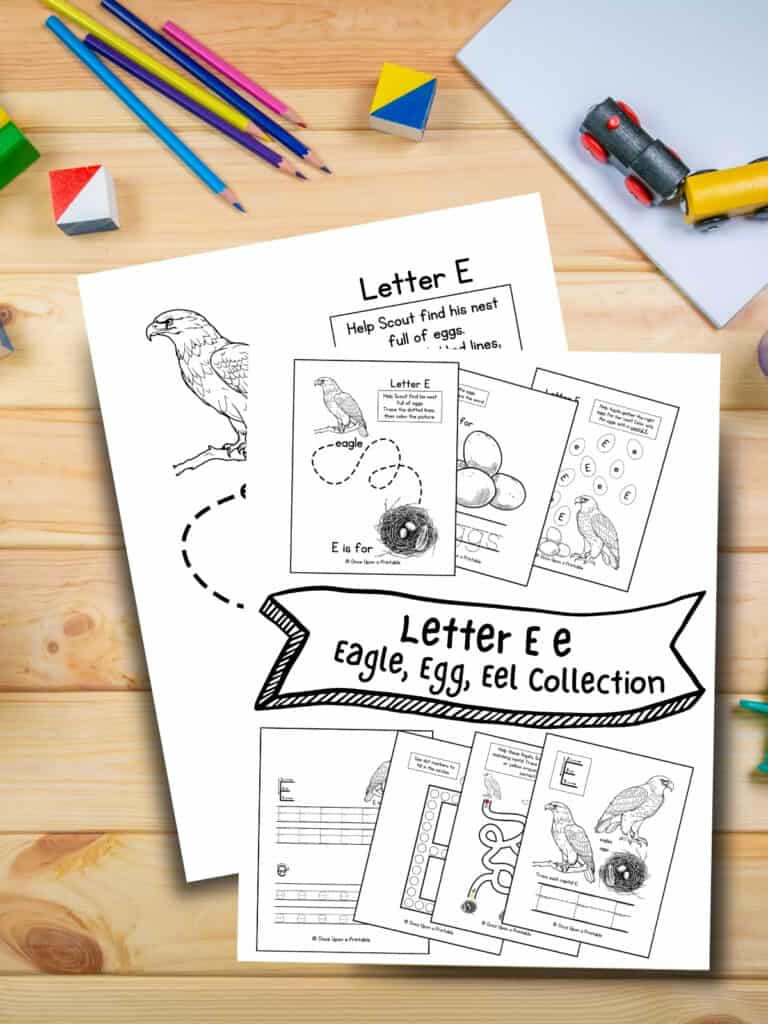 Letter E eagle egg and eel worksheets laying on a wooden table with coloring pencils.