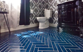 Blue herringbone floor tiles - insights from Opal Baths on what flooring is best for a bathroom.