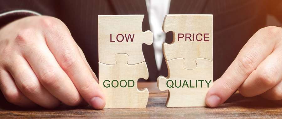 A Businessman Collects Wooden Puzzles With The Words Low Price Good Quality. The Concept Of Profitable Deals For Buyers. Small Cost Of Goods. Quality Service. Justified Money. High Rating. Marketing