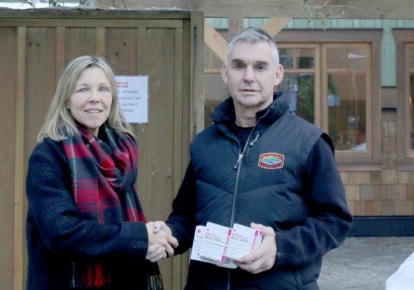 Lorinda Strang, executive director of Orchard Recovery Center hands over Naloxone kits to Bowen Island fire chief Ian Thompson