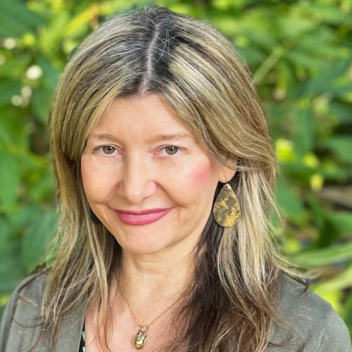 Smiling woman in front of trees - Elize Fitzgerald, Orchard Recovery Center Counsellor