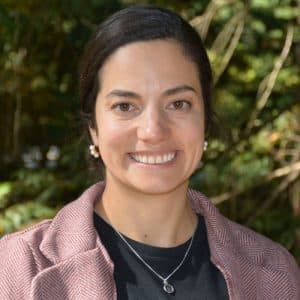 Smiling woman in front of trees