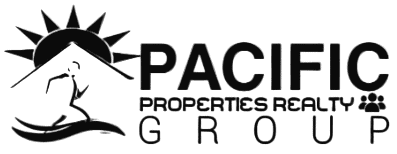 A smiling real estate agent holding keys outside a house.