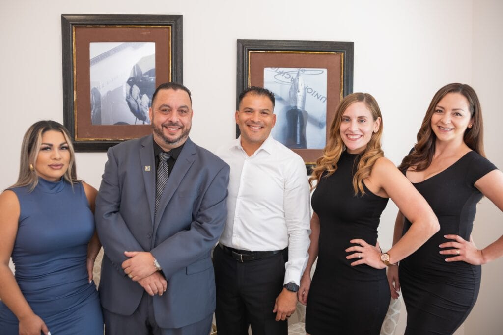 Friendly real estate team at Pacific Properties Realty Group smiling at the camera.