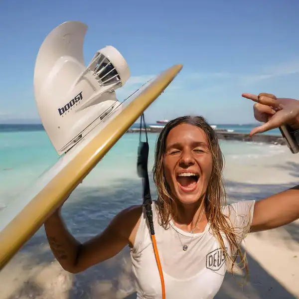 Surfing with paddleboard and motor on tropical beach.