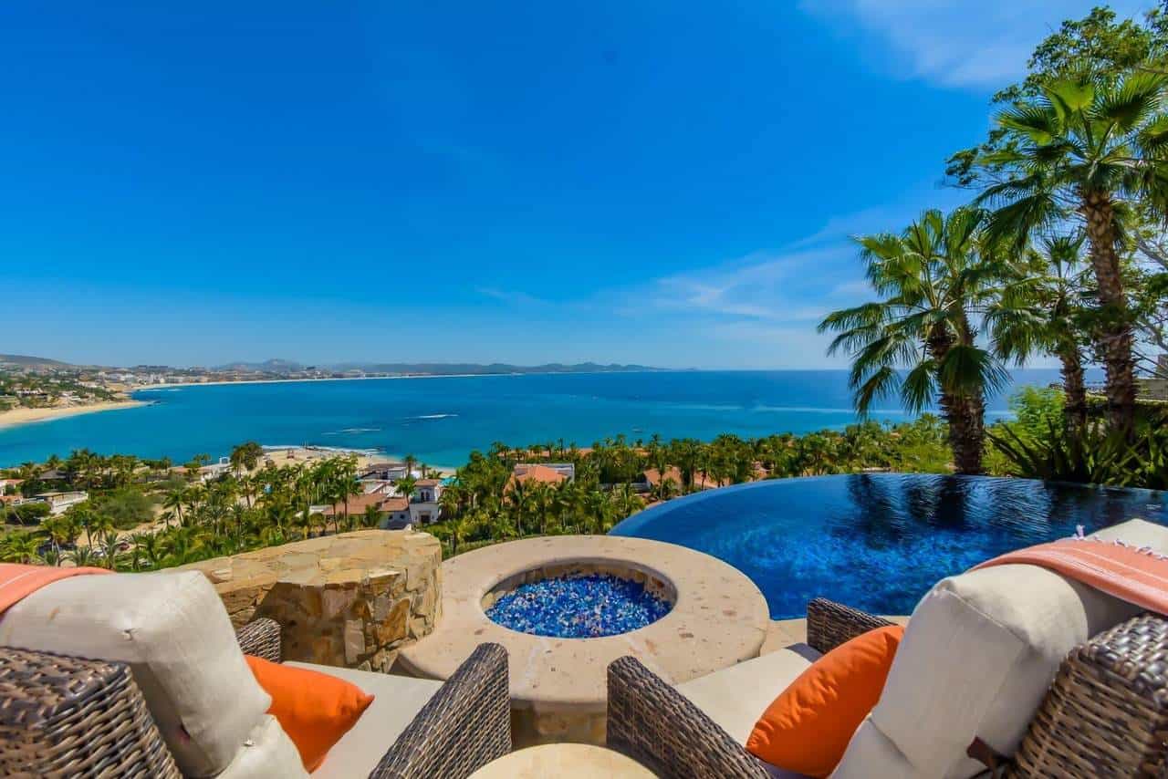 A Pool With A View Of The Ocean And A Beach