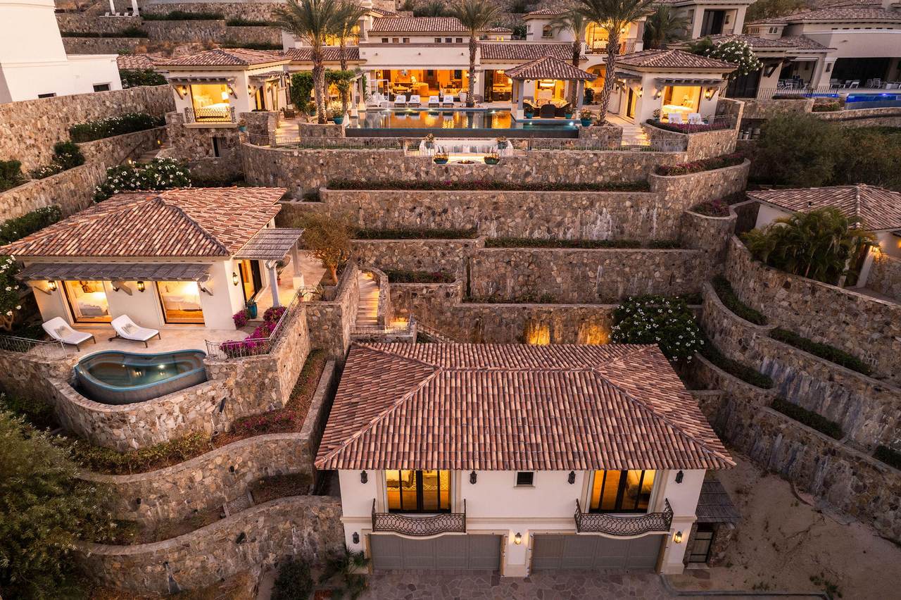 A Large House With A Pool And A Pool In The Middle Of It