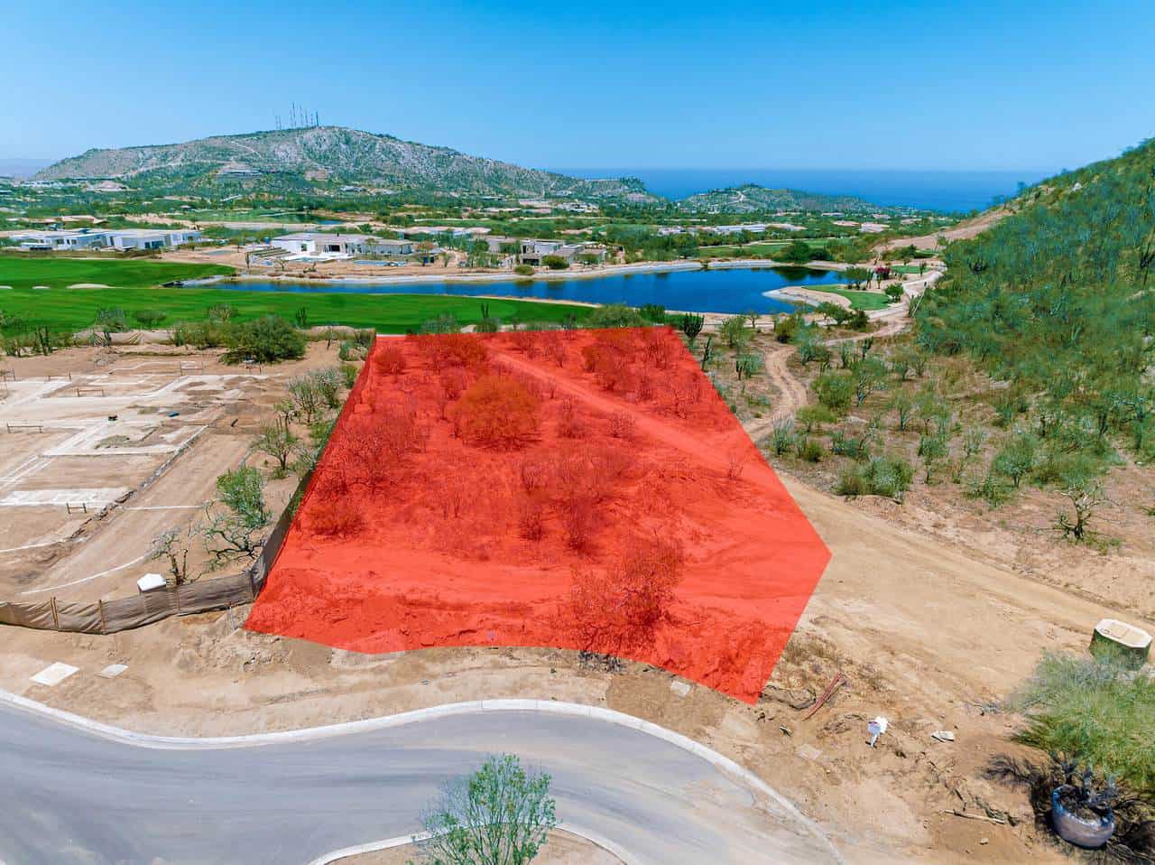 A Red Square On A Dirt Road Surrounded By Trees And Water