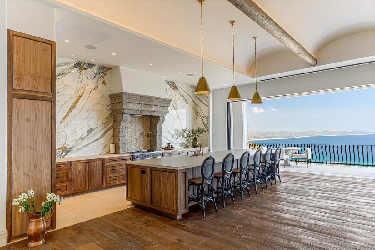 Spacious Gourmet Kitchen At La Montaña 7, A Palmilla Villas Del Mar Luxury Estate For Sale, Featuring Marble Finishes, Large Island With Seating, And Panoramic Views Of The Sea Of Cortez In Los Cabos.