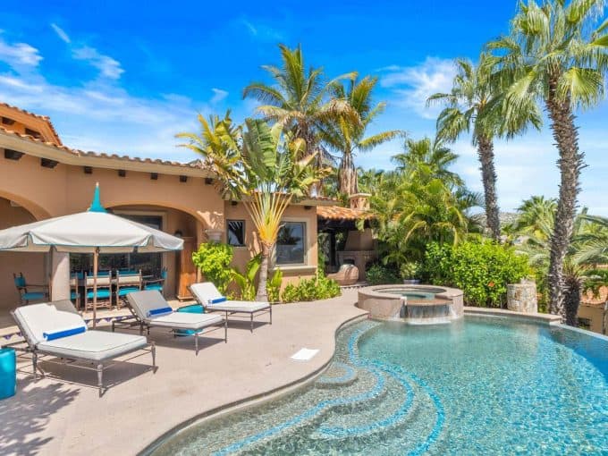 Lush Palmilla Estate With A Luxurious Pool, Surrounded By Tropical Palm Trees And Vibrant Greenery, Perfect For Relaxing And Enjoying Sunny Days In Palmilla.