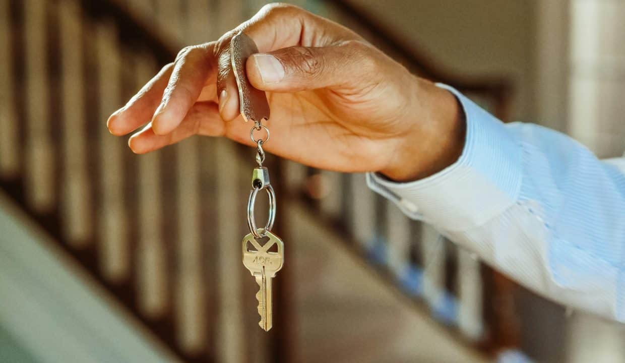 Key Being Handed Over From A Hand Holding A Keychain To Another, Symbolizing Real Estate Transactions At Palmilla.