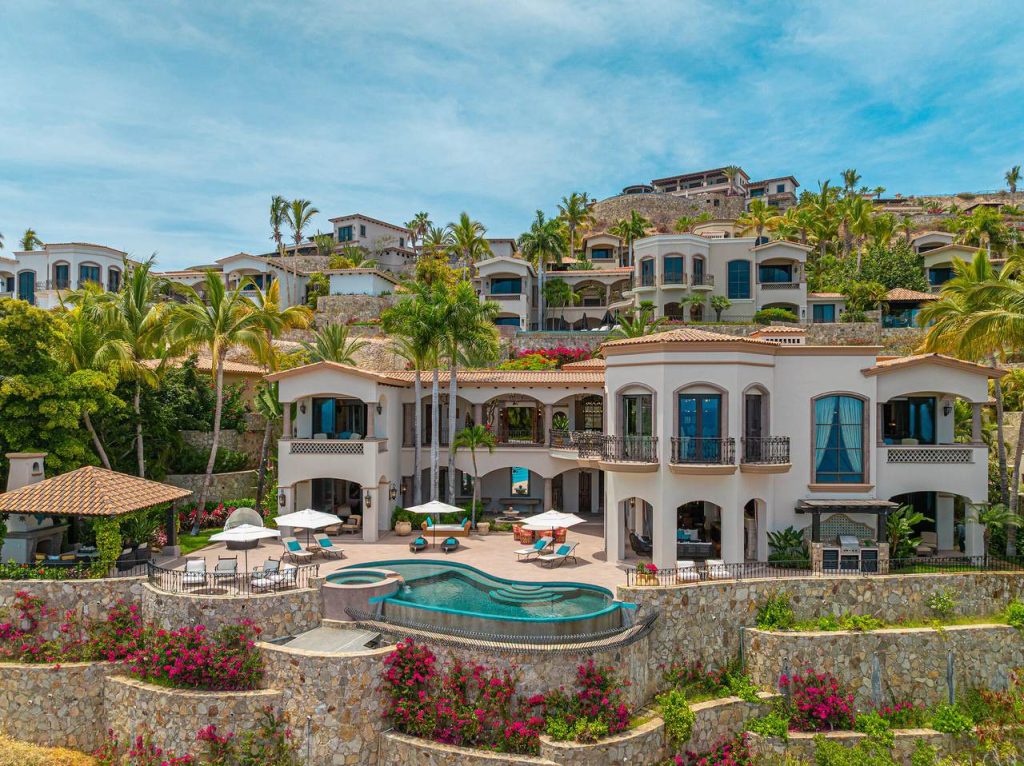 Exterior View Of Hacienda 505, A Luxury Oceanfront Villa In Villas Del Mar, San José Corridor, Featuring An Infinity-Edge Pool, Terraces, Lush Landscaping, And Panoramic Ocean Views.