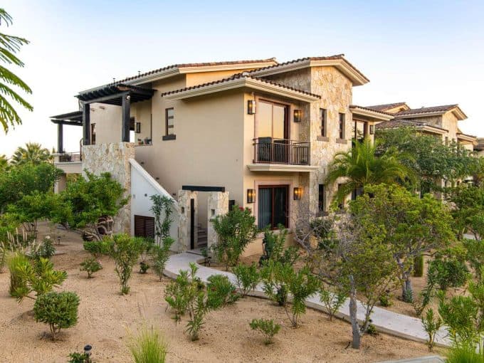 Luxurious Palmilla Residential Homes Surrounded By Lush Landscaping And Desert-Style Gardens, Showcasing Elegant Architecture And Scenic Outdoor Spaces In A Gated Community.