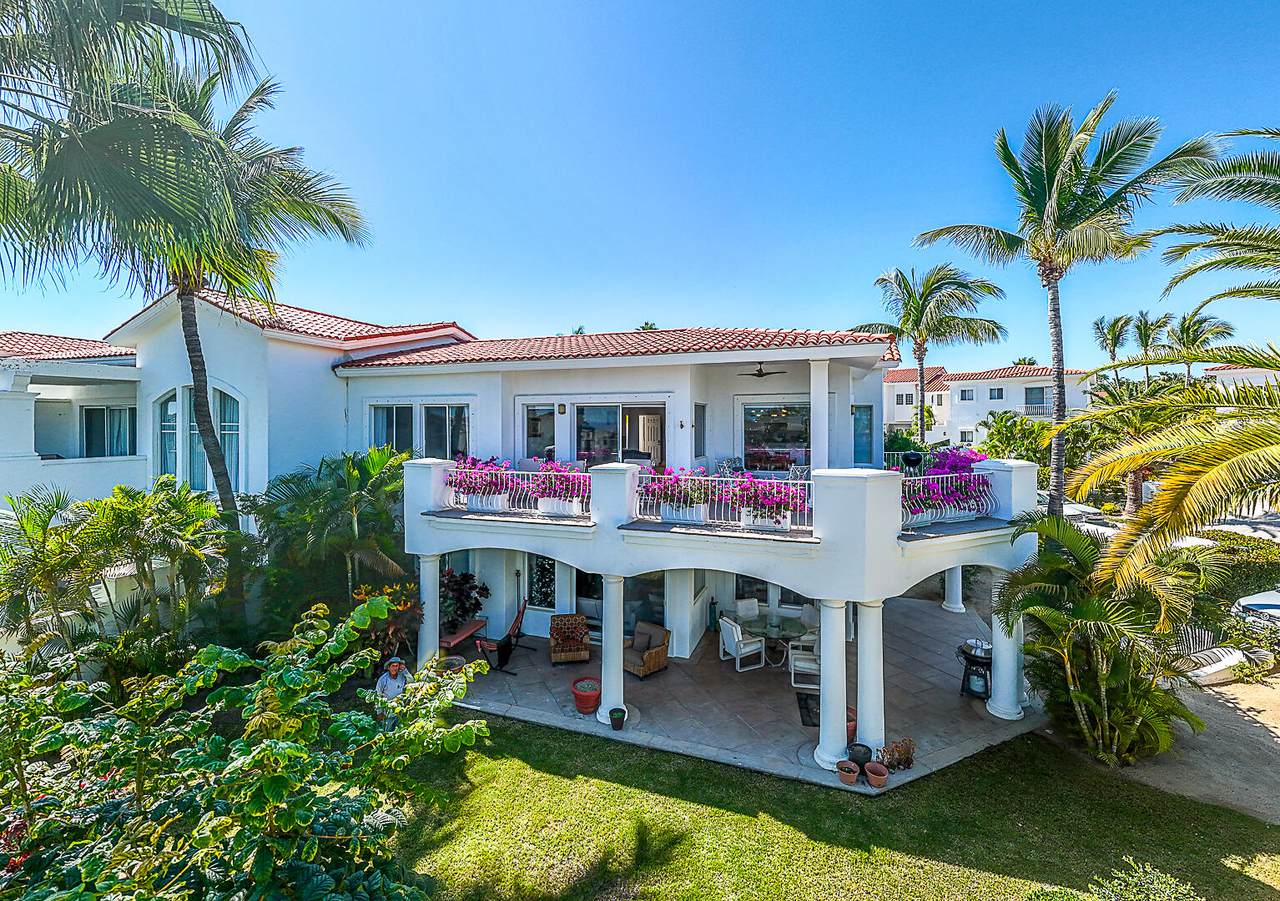 Luxurious Palmilla Beachfront Villa With Lush Tropical Landscaping, Spacious Balcony, And Elegant Outdoor Living Spaces Perfect For Relaxing In Paradise.