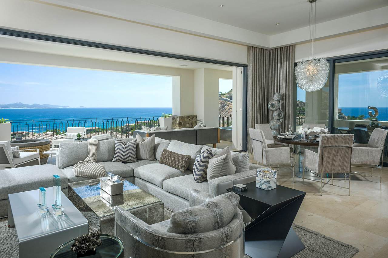Luxurious Palmilla Living Room With Ocean Views, Modern Decor, And Spacious Seating Area, Showcasing Elegant Interior Design And Stunning Coastal Scenery In A High-End Property.
