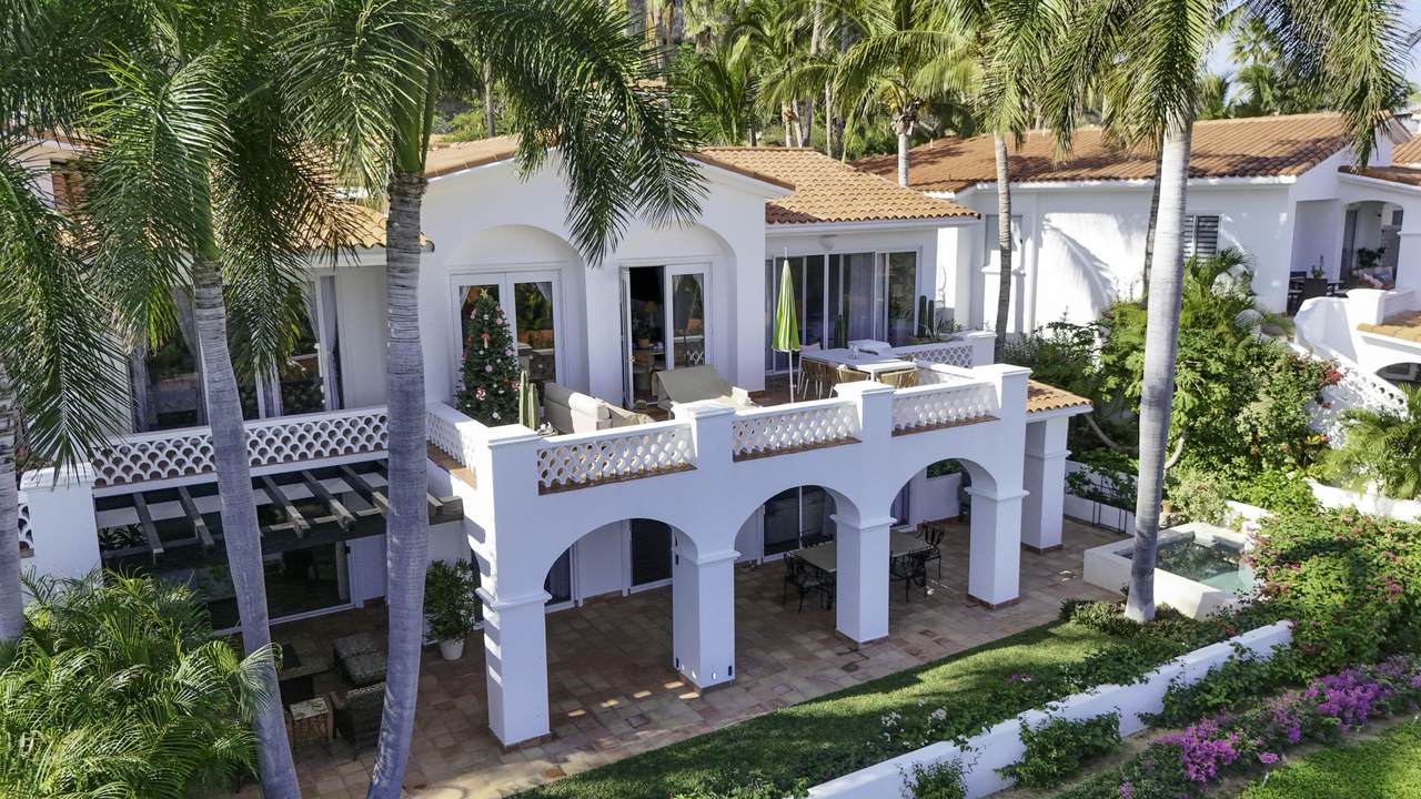 Stunning Palmilla Luxury Home With A Spacious Balcony, Lush Tropical Landscaping, And Vibrant Flowers In A Serene Coastal Neighborhood. Perfect For Upscale Living Or Investing In Real Estate.