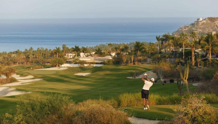 Golfer Taking A Tee Shot At Palmilla Golf Course Los Cabos With Ocean Views And Desert Landscape.