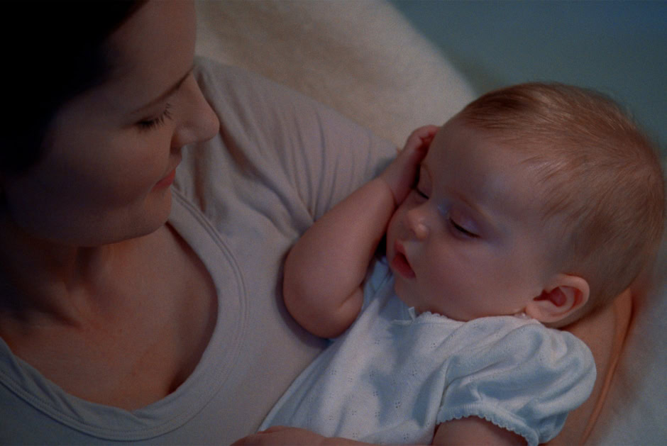 Soft focus portrait of a mother and her young child sharing an intimate moment, capturing genuine emotion and tenderness in a professional portrait style.