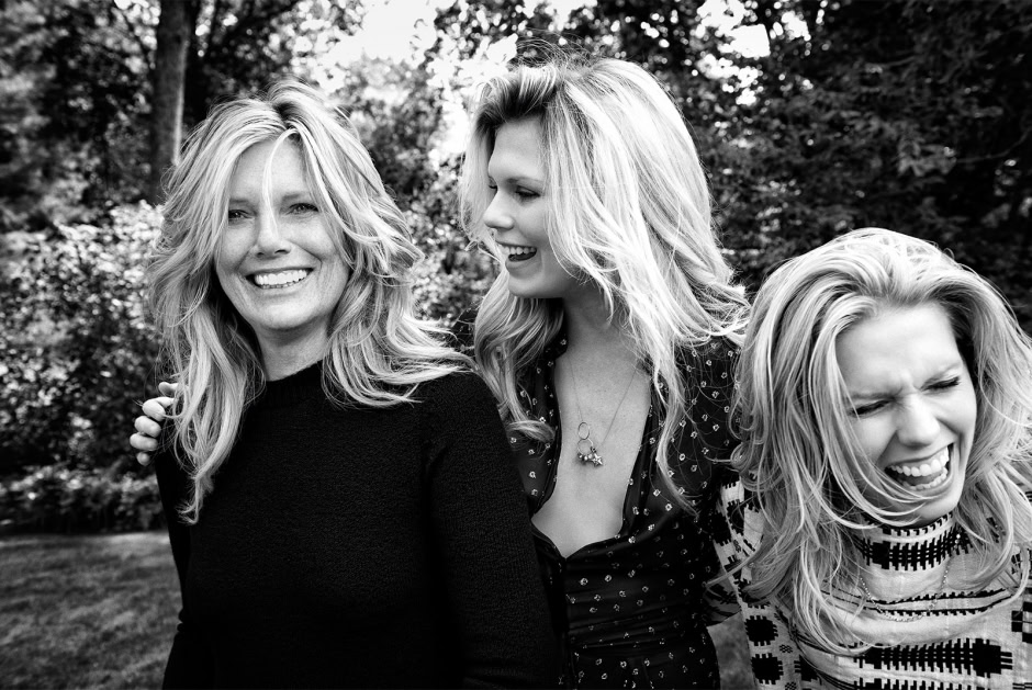 Portrait of three happy women smiling outdoors, black and white photography, natural light, candid moment, professional portrait photography.