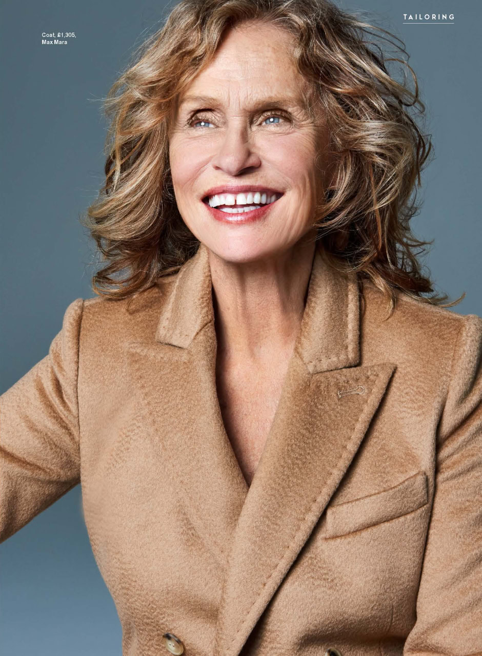 Elegant portrait of mature woman with shoulder-length wavy hair smiling, wearing a tan tailored coat, professional fashion photography, high-quality image for lifestyle and portrait photography by Pamela Hanson.