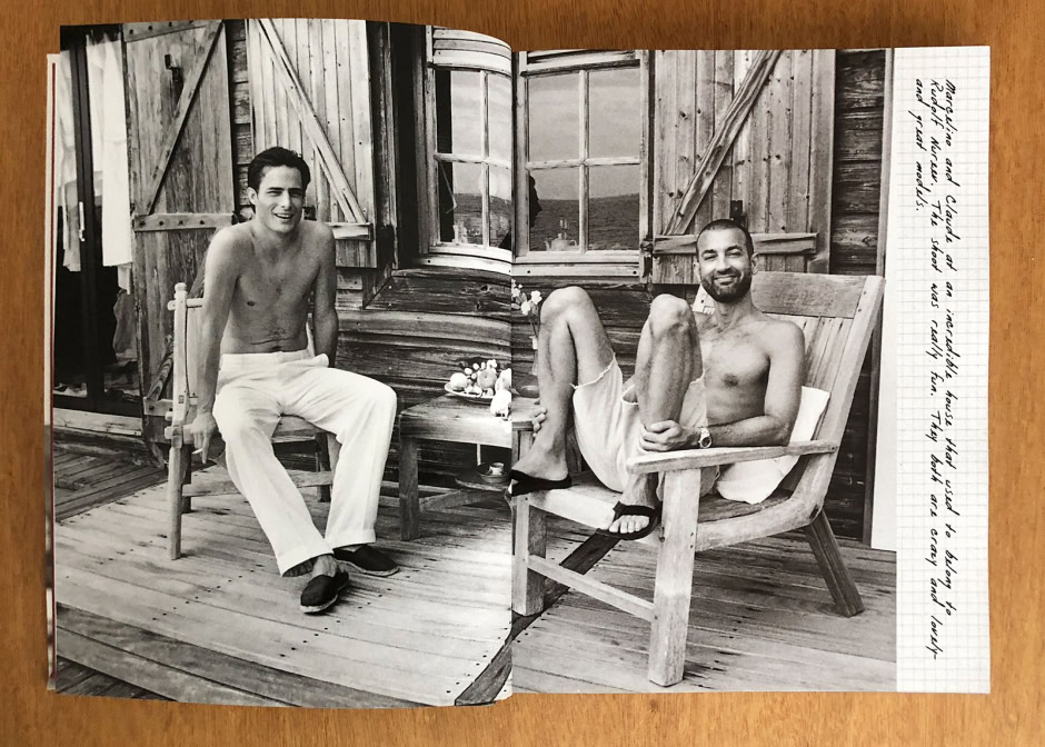 Relaxed male models shirtless on rustic wooden porch with Adirondack chairs and open window, capturing a candid moment in natural light and emphasizing casual summer lifestyle.